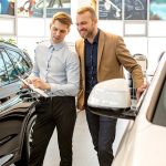 People in a dealership speaking about cars | Is the Auto Industry Facing a Decline in 2022? | Safeguard