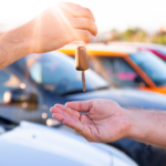 Person Handing Someone Car Keys | Looking Ahead: The Automotive Industry Outlook for 2023 | Safeguard