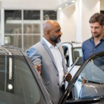 Man Selling A Couple A Car | 3 Ways Small Automotive Operations are Protecting Their Business This Year | Safeguard