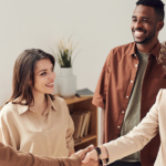People Smiling and Shaking Hands | Talent Management: 4 Strategies to Attract and Retain Top Talent | Safeguard